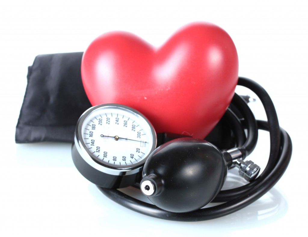 Black tonometer and heart isolated on white