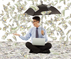 young business man holding a umbrella with dollar rain